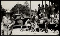 American Women's Hospitals, Rural Services mobile clinic vaccinating a boy (photograph), circa 1935<blockquote class="juicy-quote">An American Women’s Hospital doctor ( in “AWH” armband) tries to administer a shot to a local child in Jellico, Tennessee.</blockquote><div class="view-evidence"><a href="https://doctordoctress.org/islandora/object/islandora:1859/story/islandora:2087" class="btn btn-primary custom-colorbox-load"><span class="glyphicon glyphicon-search"></span> Evidence</a></div>